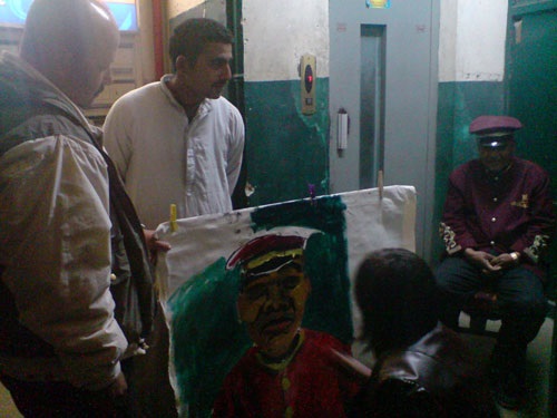 People are watching how Evgeniia is painting a portrait.